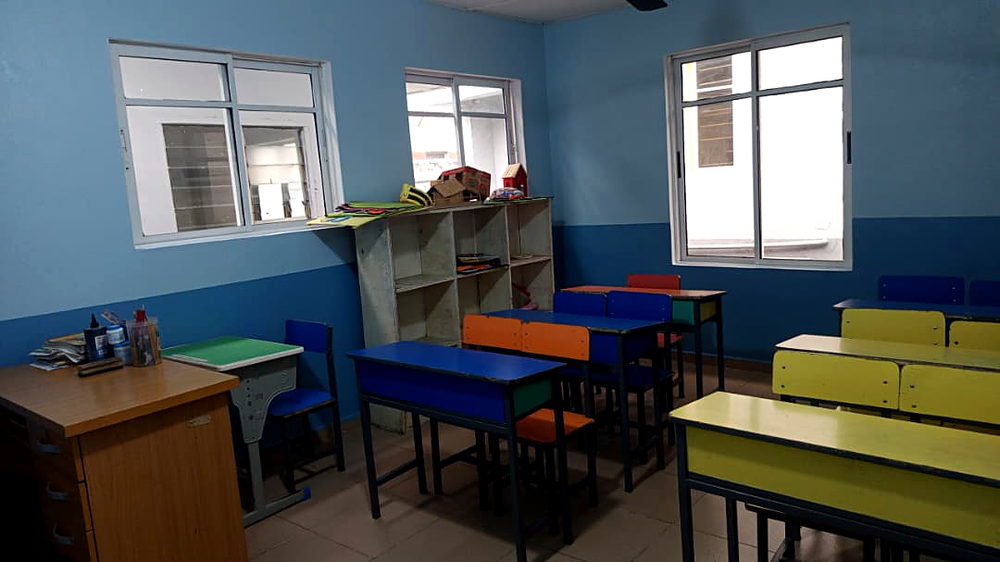 Bright classroom with colourful desks at Flourish Playhouse